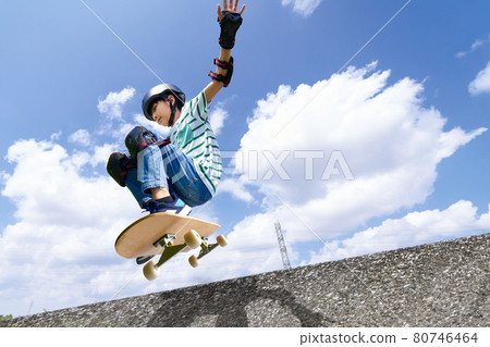Boy jumping on a skateboard 80746464