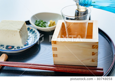 將冷清酒倒入盒子和玻璃杯中 將冷清酒倒入盒子和玻璃杯中 80748058