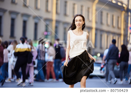 Young woman 18 years on crowded city street in evening. Young woman 18 years on crowded city street in evening. 80750429