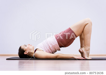 Woman doing fitness at home against wall background Woman doing fitness at home against wall background 80751636