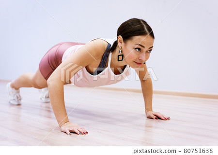 happy woman doing sports at home against wall background 80751638