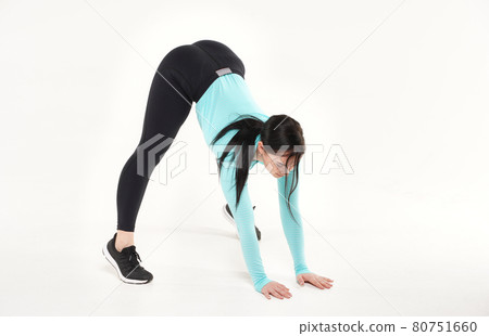 Young athletic woman making yoga and gymnastics stretching exercises isolated on white Young athletic woman making yoga and gymnastics stretching exercises isolated on white 80751660