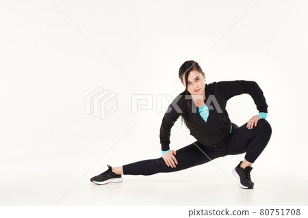 Young athletic woman making yoga and gymnastics stretching exercises isolated on white Young athletic woman making yoga and gymnastics stretching exercises isolated on white 80751708
