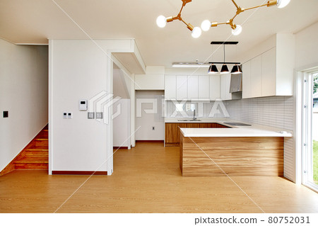 Table and dining table in a clean and simple modern open kitchen Table and dining table in a clean and simple modern open kitchen 80752031