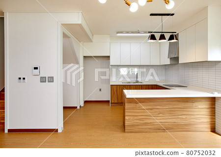 Table and dining table in a clean and simple modern open kitchen Table and dining table in a clean and simple modern open kitchen 80752032