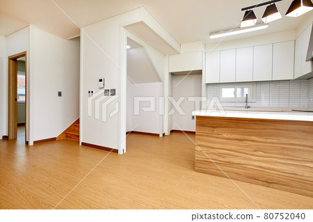 Table and dining table in a clean and simple modern open kitchen 80752040