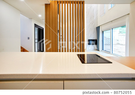 Table and dining table in a clean and simple modern open kitchen Table and dining table in a clean and simple modern open kitchen 80752055