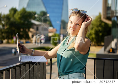 Young woman uses laptop for remote work. Young woman uses laptop for remote work. 80752217