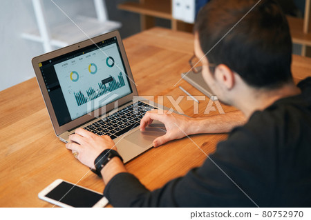 Closeup of man working on laptop with finances or ceo, graph, business analytics and strategy Closeup of man working on laptop with finances or ceo, graph, business analytics and strategy 80752970