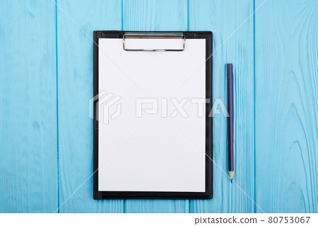 Planner on the blue wooden working table. Blank white paper on working desk Planner on the blue wooden working table. Blank white paper on working desk 80753067