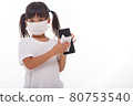Asian girl wear mask cleaning smartphone screen with alcohol.on white background. Concept of Cleaning dirty screen phone for disease prevention from bacteria. 80753540