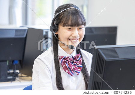 戴耳機看電腦的女學生拍攝合作：中央工業大學附屬日本語學校 80754226