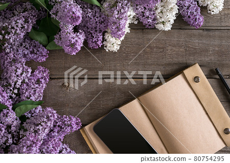 Lilac blossom on rustic wooden background with notebook for greeting message. Top view Lilac blossom on rustic wooden background with notebook for greeting message. Top view 80754295