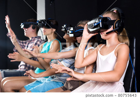 Girl is excited by watching the video in VR glasses Girl is excited by watching the video in VR glasses 80755643