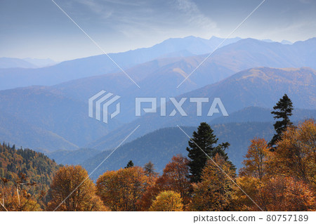 Amazing mountain range in the blue haze of an autumn morning Amazing mountain range in the blue haze of an autumn morning 80757189