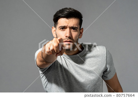 Young handsome Caucasian man looking and pointing finger at you Young handsome Caucasian man looking and pointing finger at you 80757664