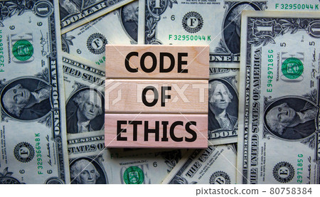 Concept text 'code of ethics' on wooden blocks on a beautiful background from dollar bills. Concept text 'code of ethics' on wooden blocks on a beautiful background from dollar bills. 80758384