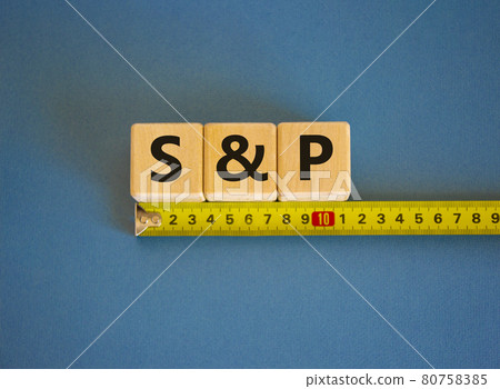 S and P 500 Index rates symbol. The word S and P on cubes arranged behind the ruler on beautiful blue background. Copy space. Business and S and P 500 Index rates concept. 80758385