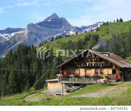 Old farm house with cow bells on the facade and Mount Oldehore. Old farm house with cow bells on the facade and Mount Oldehore. 80758391