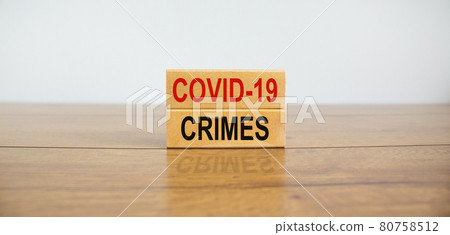 Wooden blocks form the text 'covid-19 crimes' on beautiful wooden table, white background. Business concept, copy space. 80758512