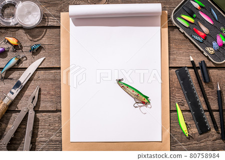 Fishing tackle - fishing spinning, fishing line, hooks and lures on wooden background. 80758984