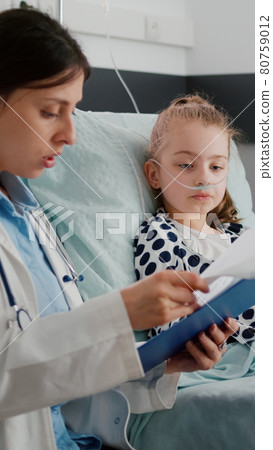 Sick child patient wearing oxygen nasal tube resting in bed recovering after breathing sickness surgery 80759012