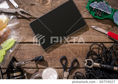 Fishing tackle - fishing spinning, fishing line, hooks and lures on wooden background. 80759027