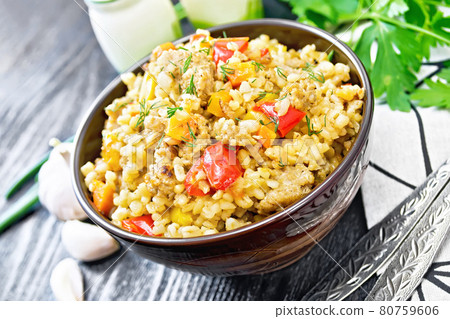 Barley porridge with minced meat in bowl on wooden board Barley porridge with minced meat in bowl on wooden board 80759606