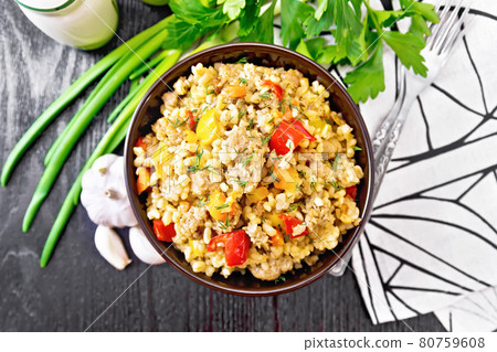 Barley porridge with minced meat in bowl on board top Barley porridge with minced meat in bowl on board top 80759608