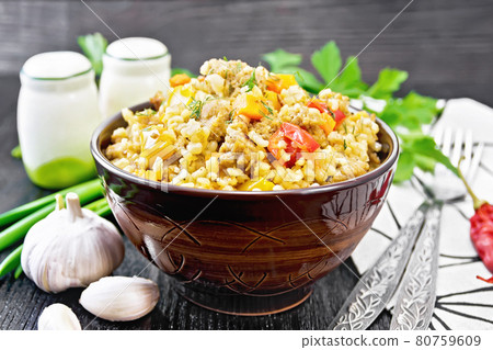 Barley porridge with minced meat in bowl on board Barley porridge with minced meat in bowl on board 80759609