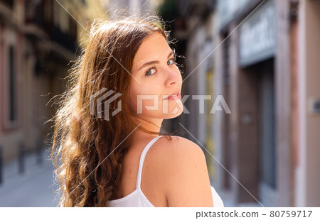 Young cheerful woman walking in city center 80759717