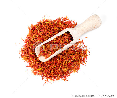 top view of scoop on safflower petals on white top view of scoop on safflower petals on white 80760936