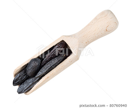 dried tonka beans in wood scoop cutout 80760940