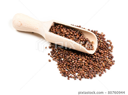 wood scoop on grains of paradise pepper on white 80760944
