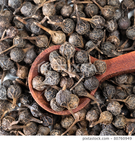 top view of spoon on pile of dried cubeb pepper top view of spoon on pile of dried cubeb pepper 80760949