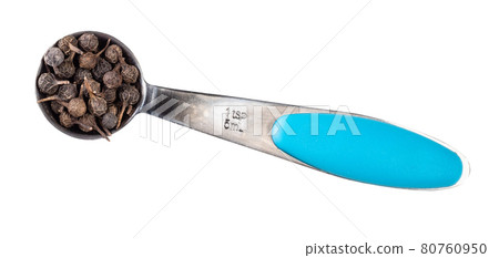 dried cubeb pepper in measuring teaspoon cutout 80760950