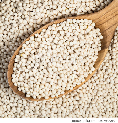 uncooked ptitim (pearl couscous) in spoon closeup uncooked ptitim (pearl couscous) in spoon closeup 80760960