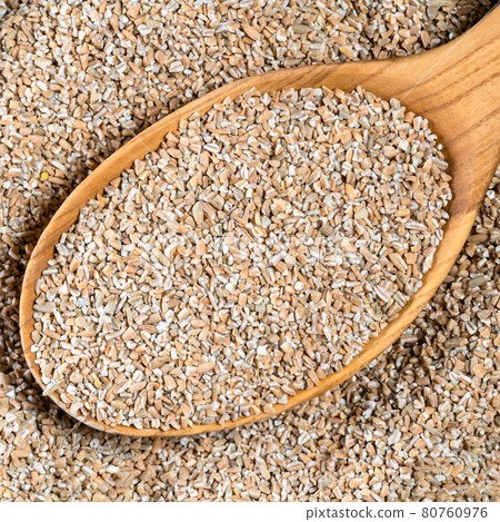 crushed rye groats in wood spoon closeup crushed rye groats in wood spoon closeup 80760976