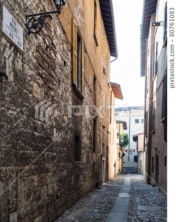 narrow medieval street Via dei Musei in Brescia 80761083
