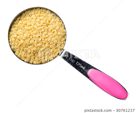 uncooked stelline pastina in measuring cup cutout 80761237