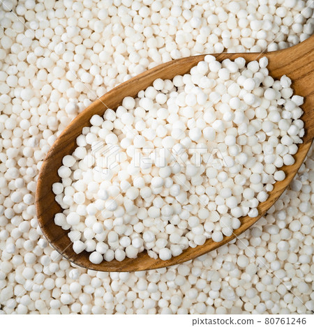 raw sabudana (tapioca sago) in wood spoon closeup raw sabudana (tapioca sago) in wood spoon closeup 80761246