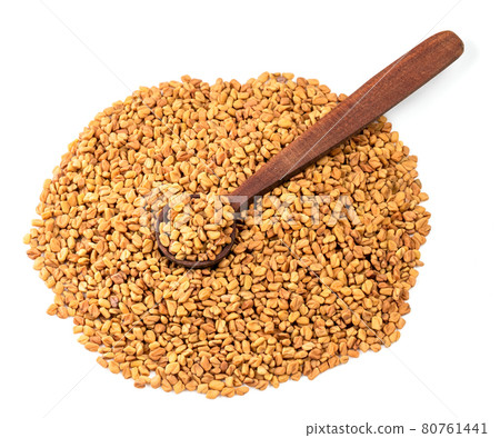 wooden spoon on pile of Fenugreek seeds on white 80761441