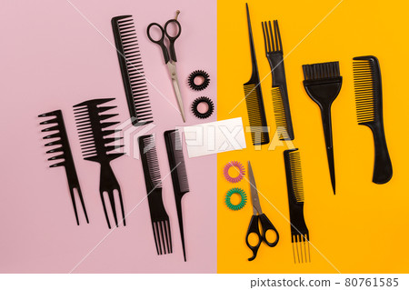 Hairdresser tools on pink and yellow background with copy space, top view, flat lay. Hairdresser tools on pink and yellow background with copy space, top view, flat lay. 80761585