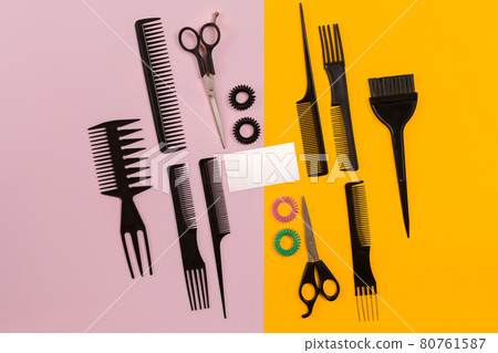 Hairdresser tools on pink and yellow background with copy space, top view, flat lay. Hairdresser tools on pink and yellow background with copy space, top view, flat lay. 80761587