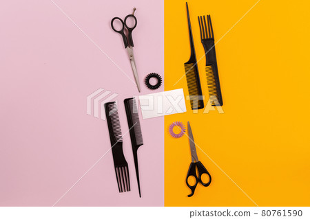 Hairdresser tools on pink and orange background with copy space 80761590