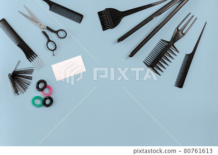 Hairdresser tools on blue background with copy space, top view, flat lay. Hairdresser tools on blue background with copy space, top view, flat lay. 80761613
