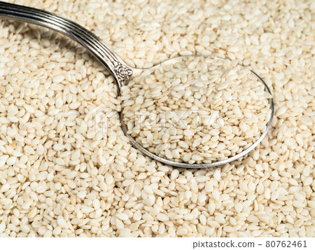 silver tablespoon in white sesame seeds silver tablespoon in white sesame seeds 80762461