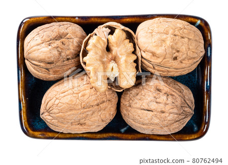 peeled and several whole walnuts in bowl cutout peeled and several whole walnuts in bowl cutout 80762494