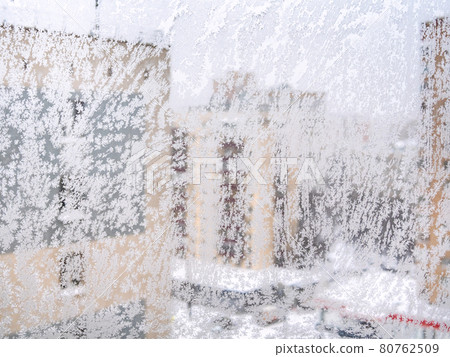 frozen home window and view of apartment houses frozen home window and view of apartment houses 80762509