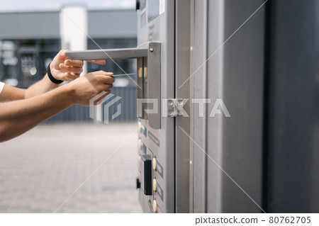 Man put plactic card for paying outdoors on self-service car wash Man put plactic card for paying outdoors on self-service car wash 80762705